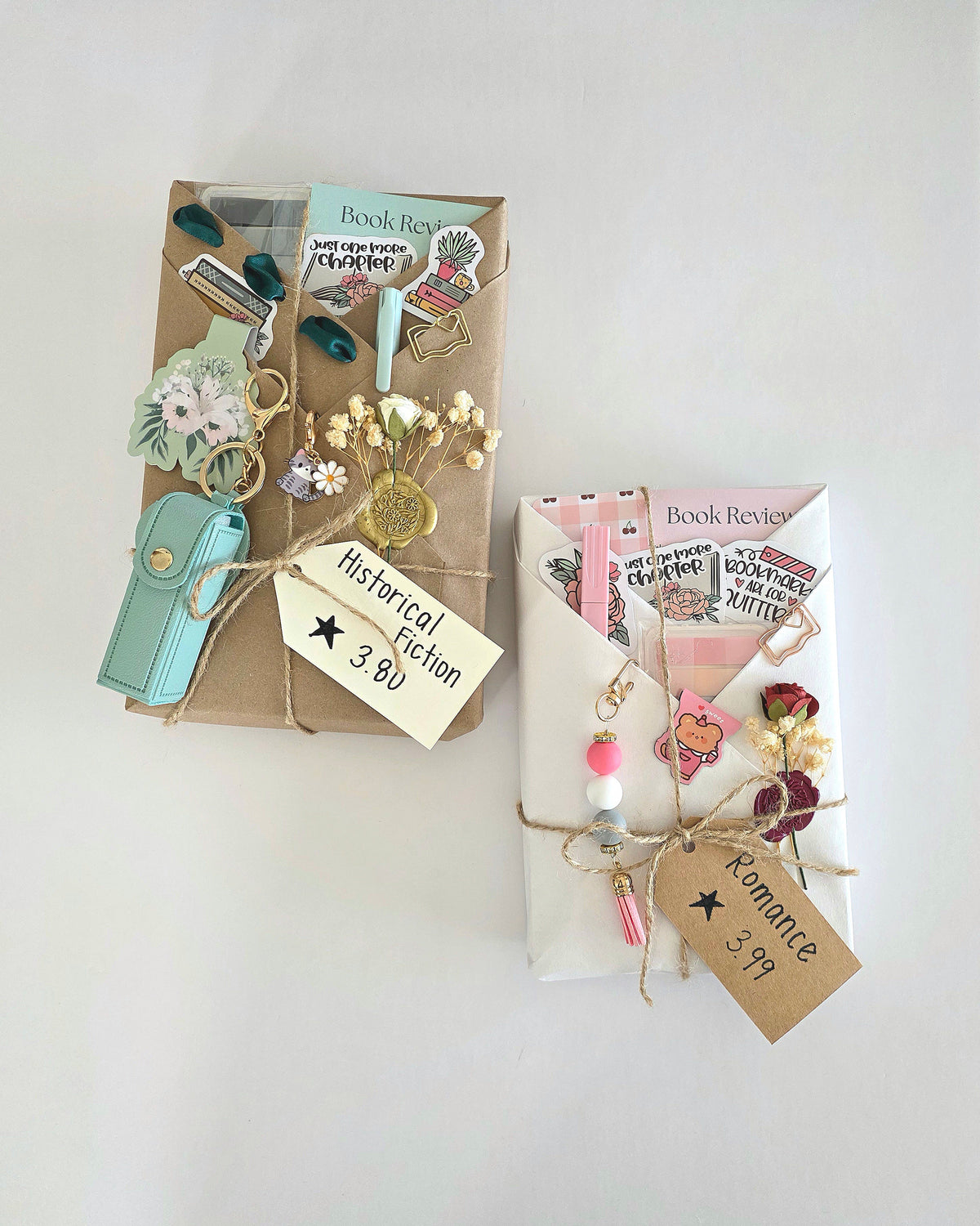Two decorated book packages on a white background, one with a kraft paper cover and one with a white envelope cover, both filled with booklets and embellished with tags, beads, and small decorative items.